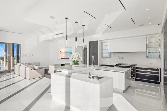 a living room with furniture large windows and wooden floor