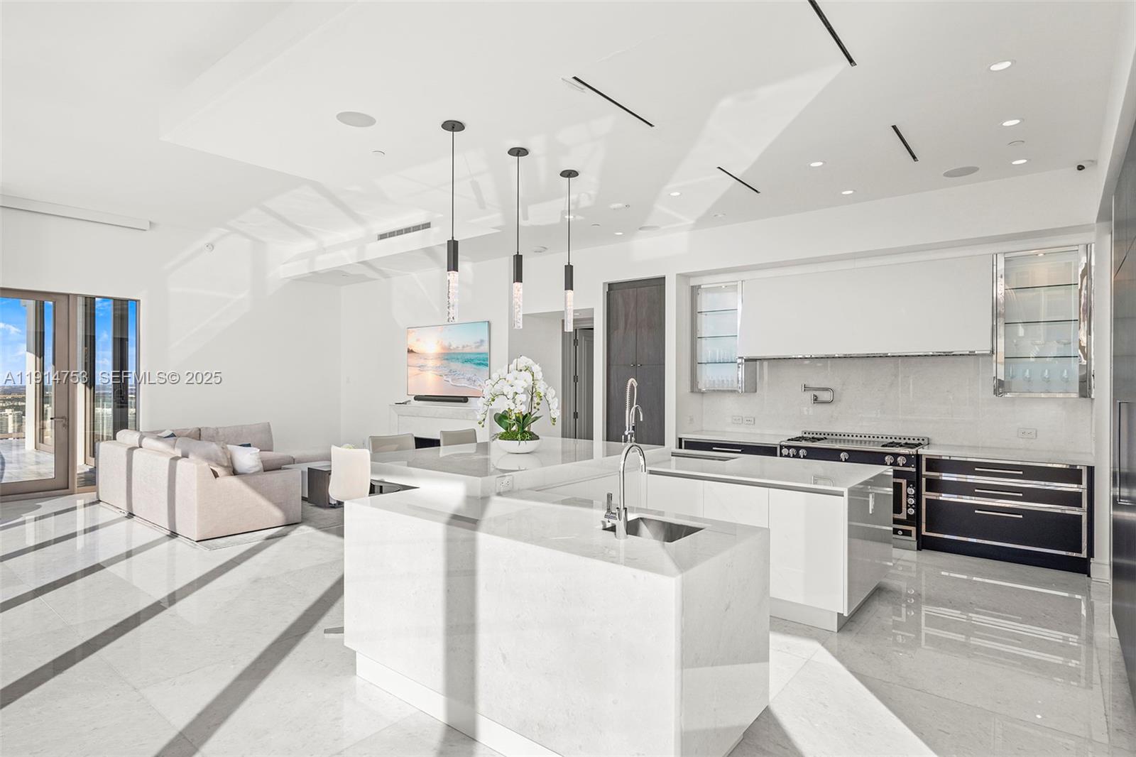 17901 Collins Avenue, Unit 4507 Sunny Isles Beach, FL 33160 - Photo 8 of 58 a large kitchen with kitchen island a sink stainless steel appliances and cabinets