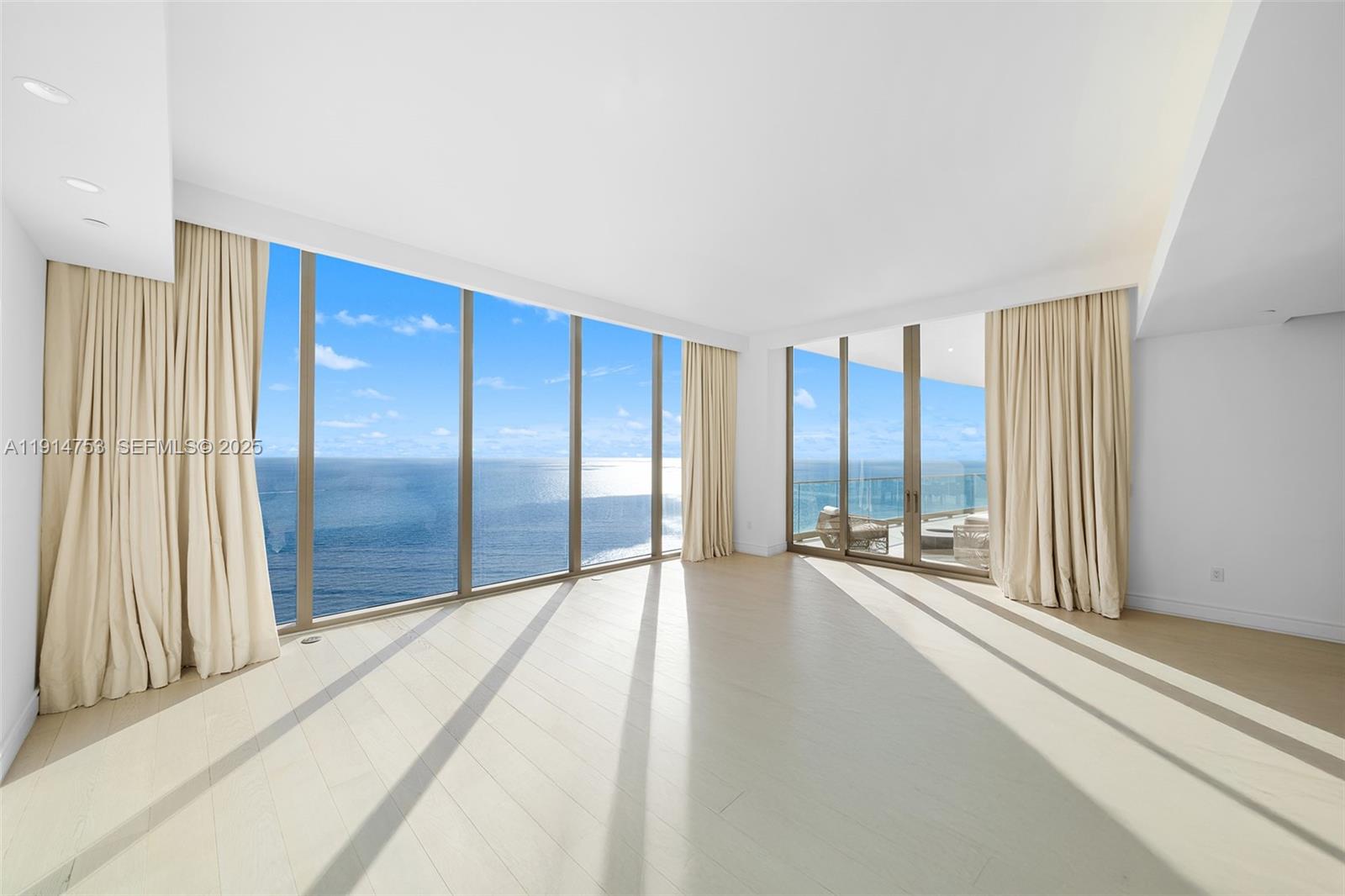 17901 Collins Avenue, Unit 4507 Sunny Isles Beach, FL 33160 - Photo 10 of 58 a view of an empty room with a sliding door