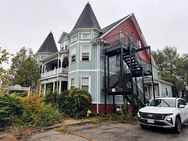 a car parked in front of white house