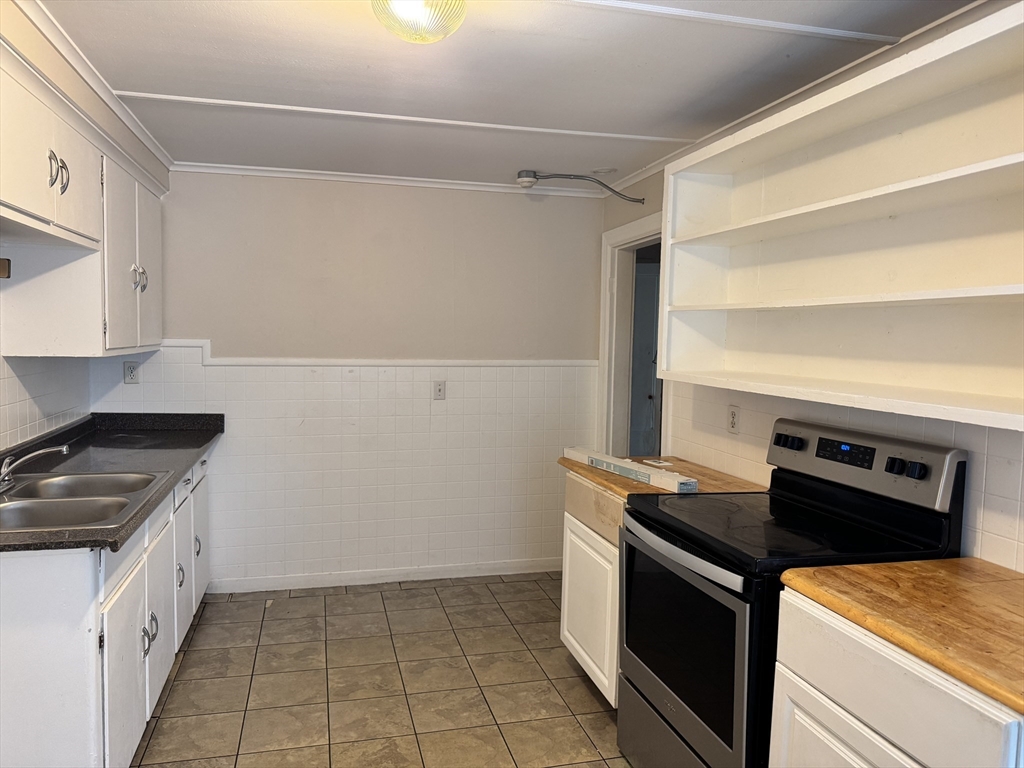 41 Pleasant Street, Unit 1 Attleboro, MA 02703 - Photo 3 of 9 a kitchen with a stove and a refrigerator