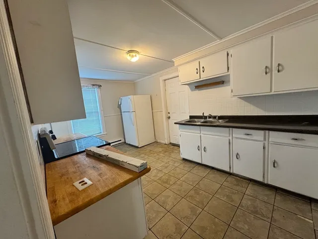 a kitchen with stainless steel appliances granite countertop a sink and cabinets