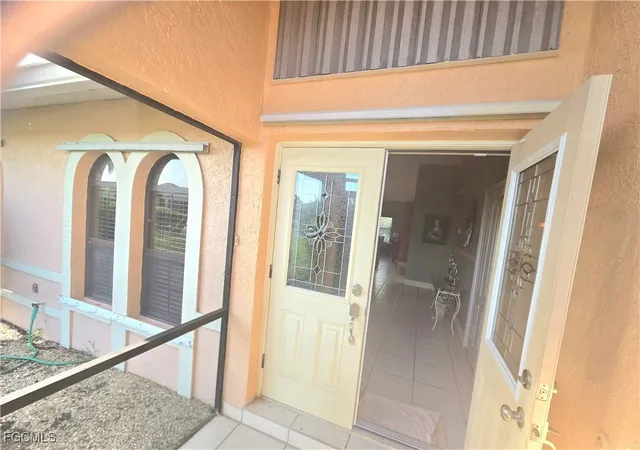 a view of a bathroom with mirror and door