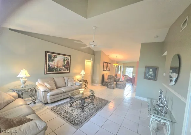 a living room with furniture and a painting on the wall