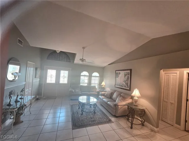 a living room with couches and chandelier