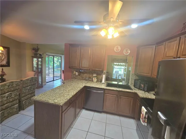 a kitchen with refrigerator and cabinets