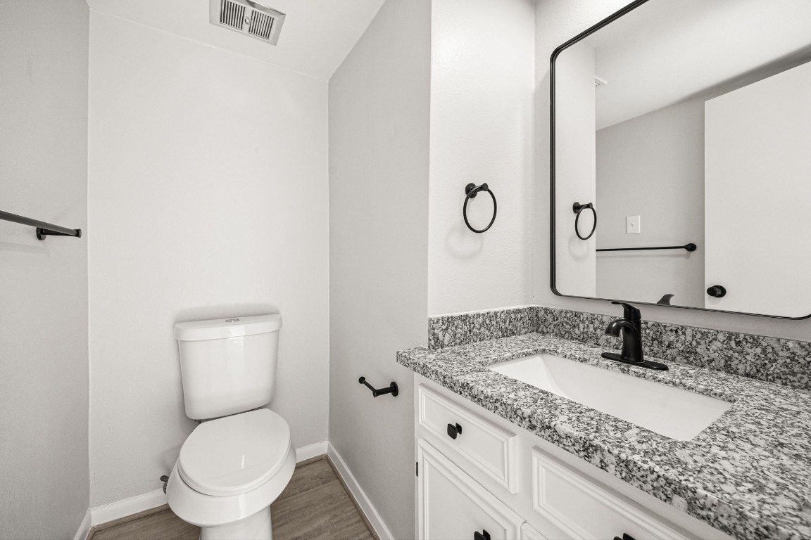 15686 Barkers Landing Road Houston, TX 77079 - Photo 11 of 32 1st Floor Powder room for guests features granite counters & contemporary fixtures/mirror.
