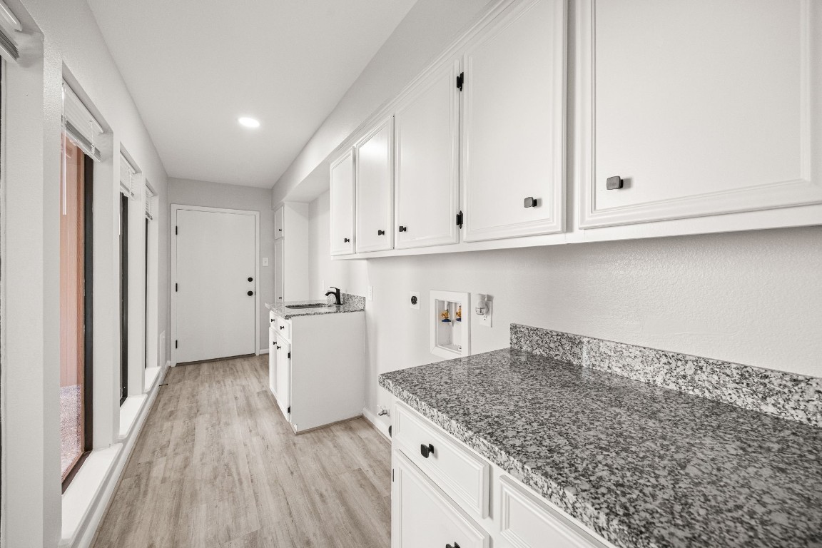 15686 Barkers Landing Road Houston, TX 77079 - Photo 17 of 32 1st Floor Laundry room is equipped with W/D connections (gas & electric), sink, additional counter & cabinet space, large windows looking out to back patio & garage entrance.