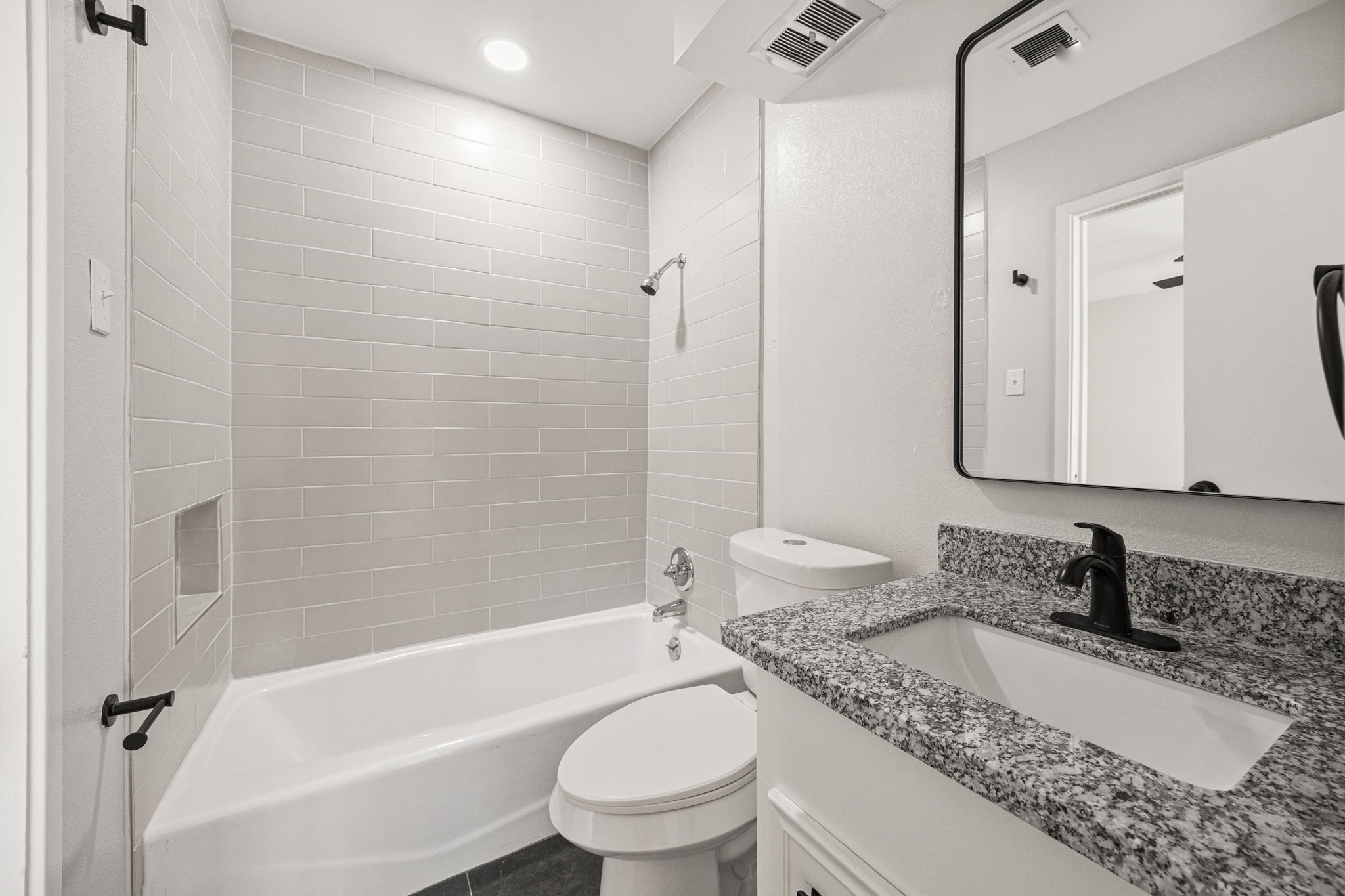 15686 Barkers Landing Road Houston, TX 77079 - Photo 20 of 32 a bathroom with a granite countertop sink toilet mirror and bathtub