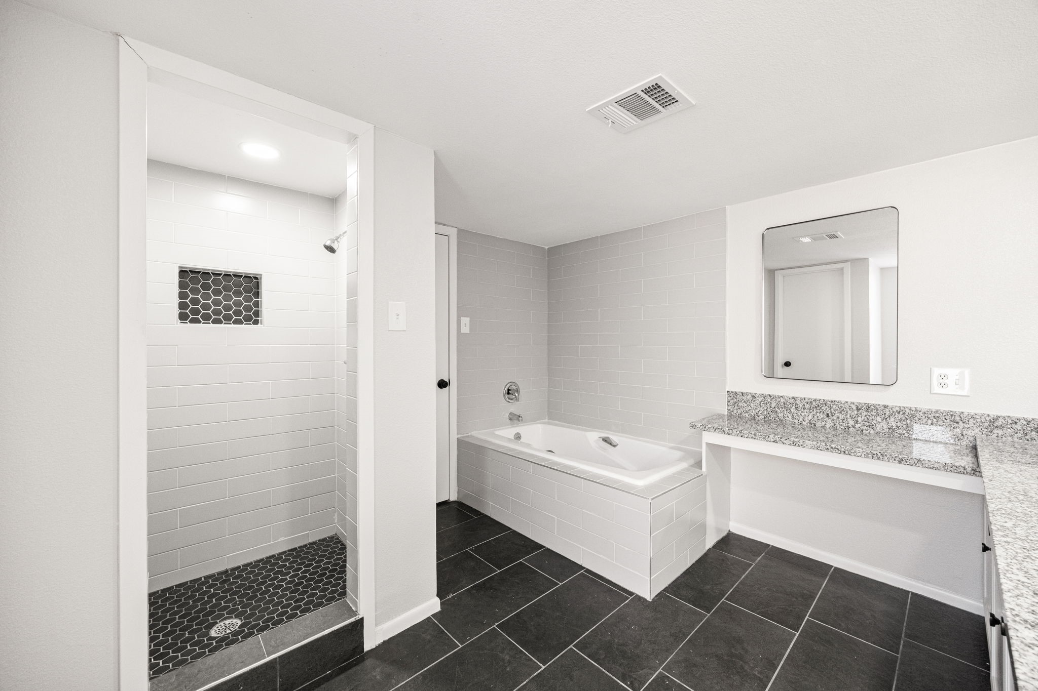 15686 Barkers Landing Road Houston, TX 77079 - Photo 24 of 32 a bathroom with a bathtub sink and a mirror