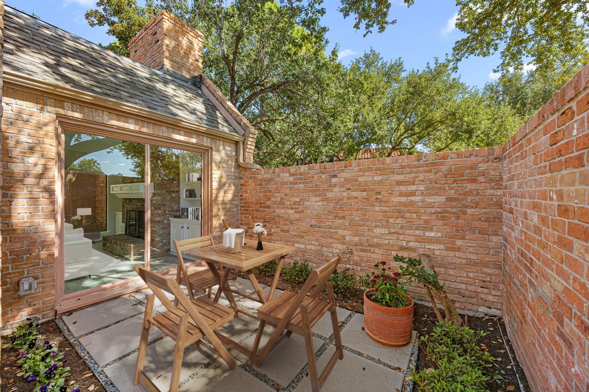15686 Barkers Landing Road Houston, TX 77079 - Photo 3 of 32 Beyond the private iron gate are two front patio areas, perfect to enjoy your coffee or outdoor entertainment for guests. Large windows let in natural light & tall brick walls create a private space.