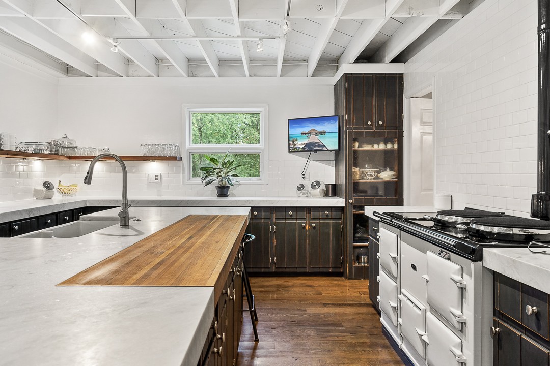 1180 Mt Vernon Road Cookeville, TN 38501 - Photo 13 of 48 a kitchen with stainless steel appliances granite countertop a sink a stove and a wooden floors