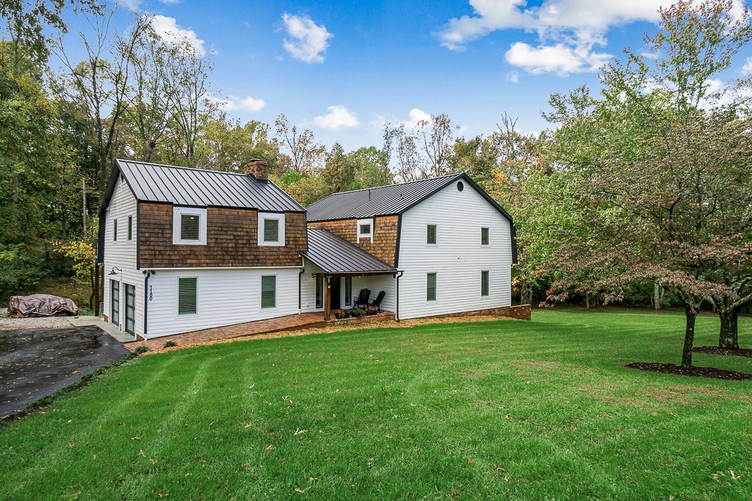 1180 Mt Vernon Road Cookeville, TN 38501 - Photo 40 of 48 a front view of a house with a garden and trees