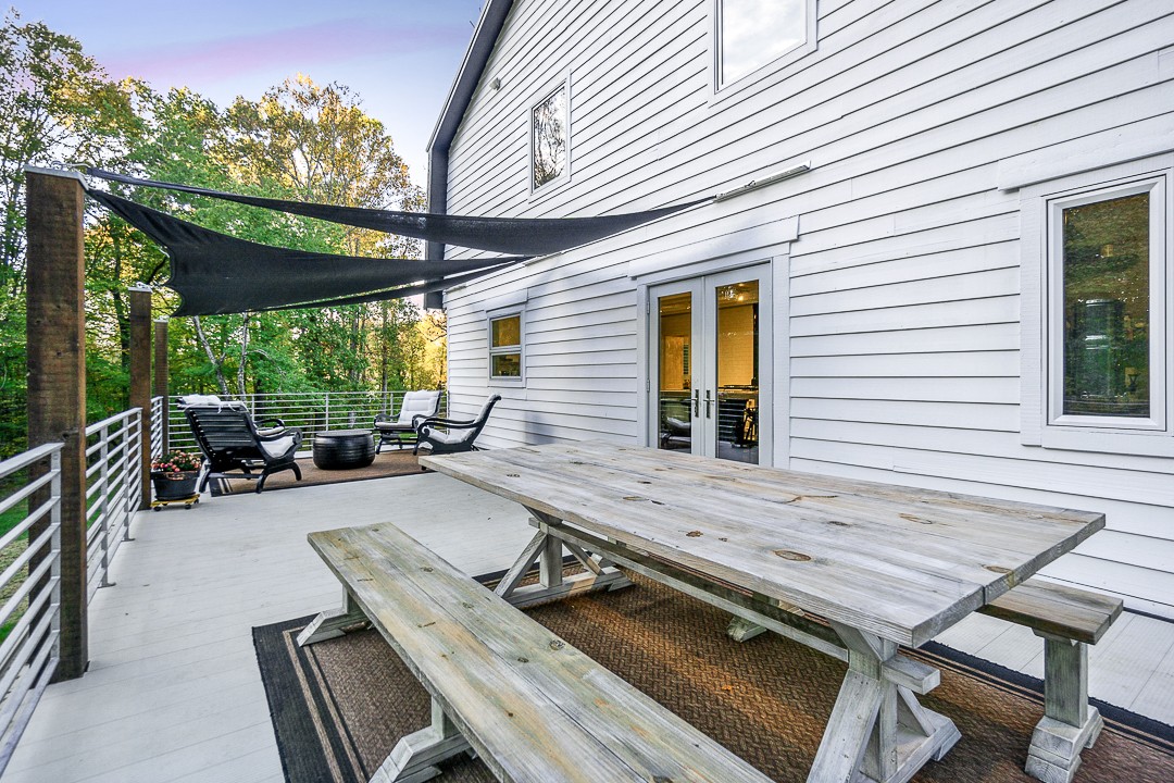 1180 Mt Vernon Road Cookeville, TN 38501 - Photo 42 of 48 a view of a patio with table and chairs with wooden floor and fence