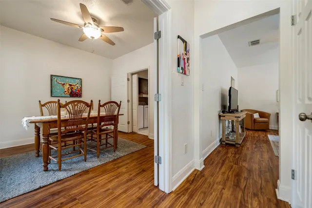 a view of a dining room with furniture and wooden floor