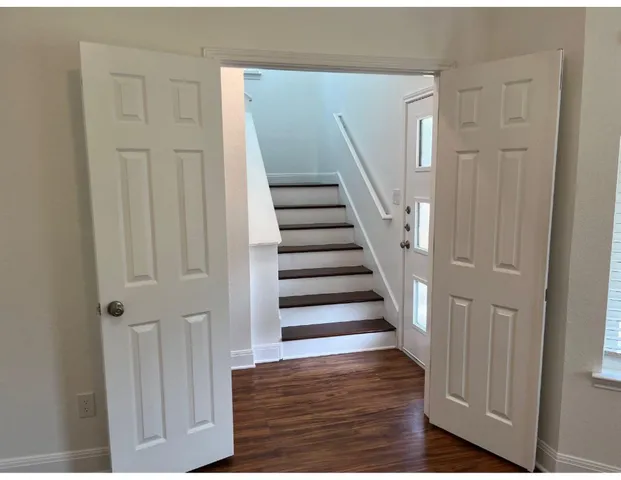 a view of entryway and hall with wooden floor