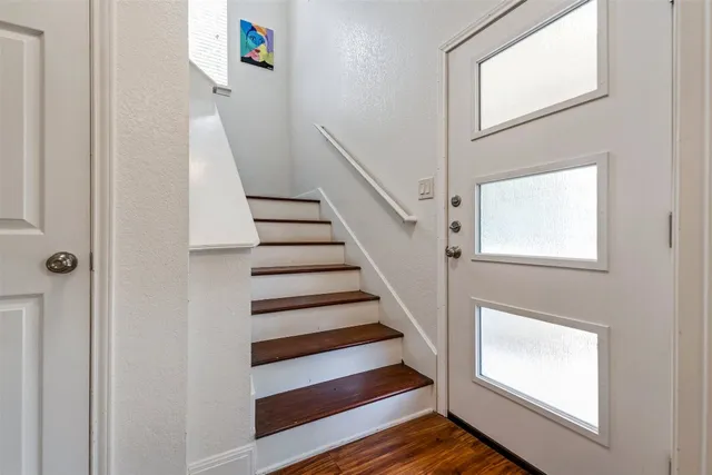 a view of entryway and hall with wooden floor