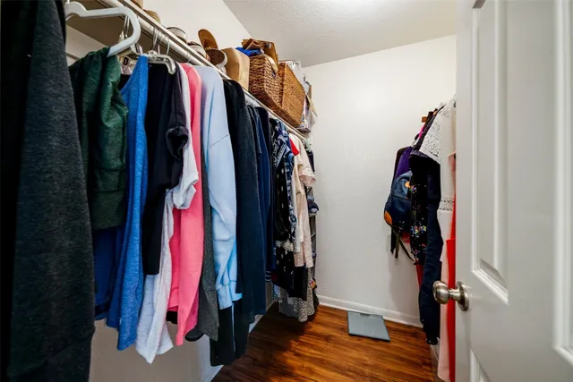 a view of walk in closet with clothes