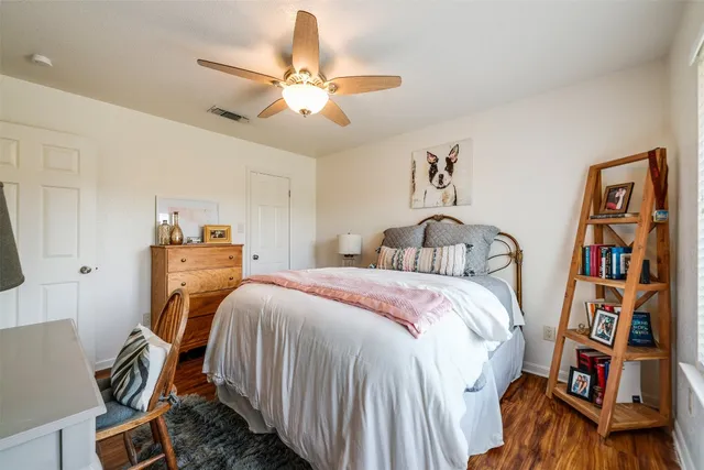 a bedroom with bed and a chandelier