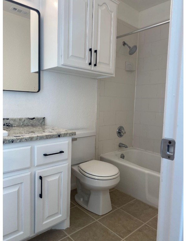 201 East 35th Street, Unit A Austin, TX 78705 - Photo 24 of 25 a bathroom with a granite countertop toilet a sink and bathtub