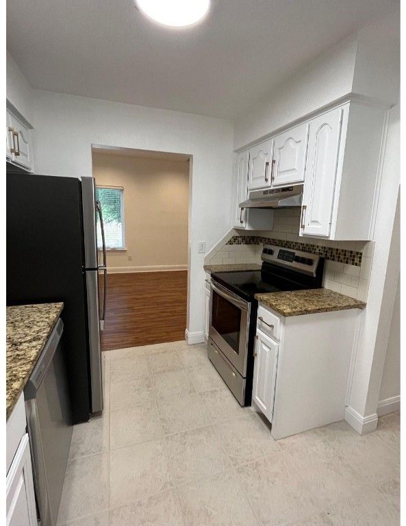 201 East 35th Street, Unit A Austin, TX 78705 - Photo 7 of 25 a kitchen with stainless steel appliances a stove a microwave and a refrigerator