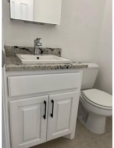 a close view of a sink a toilet and a stove