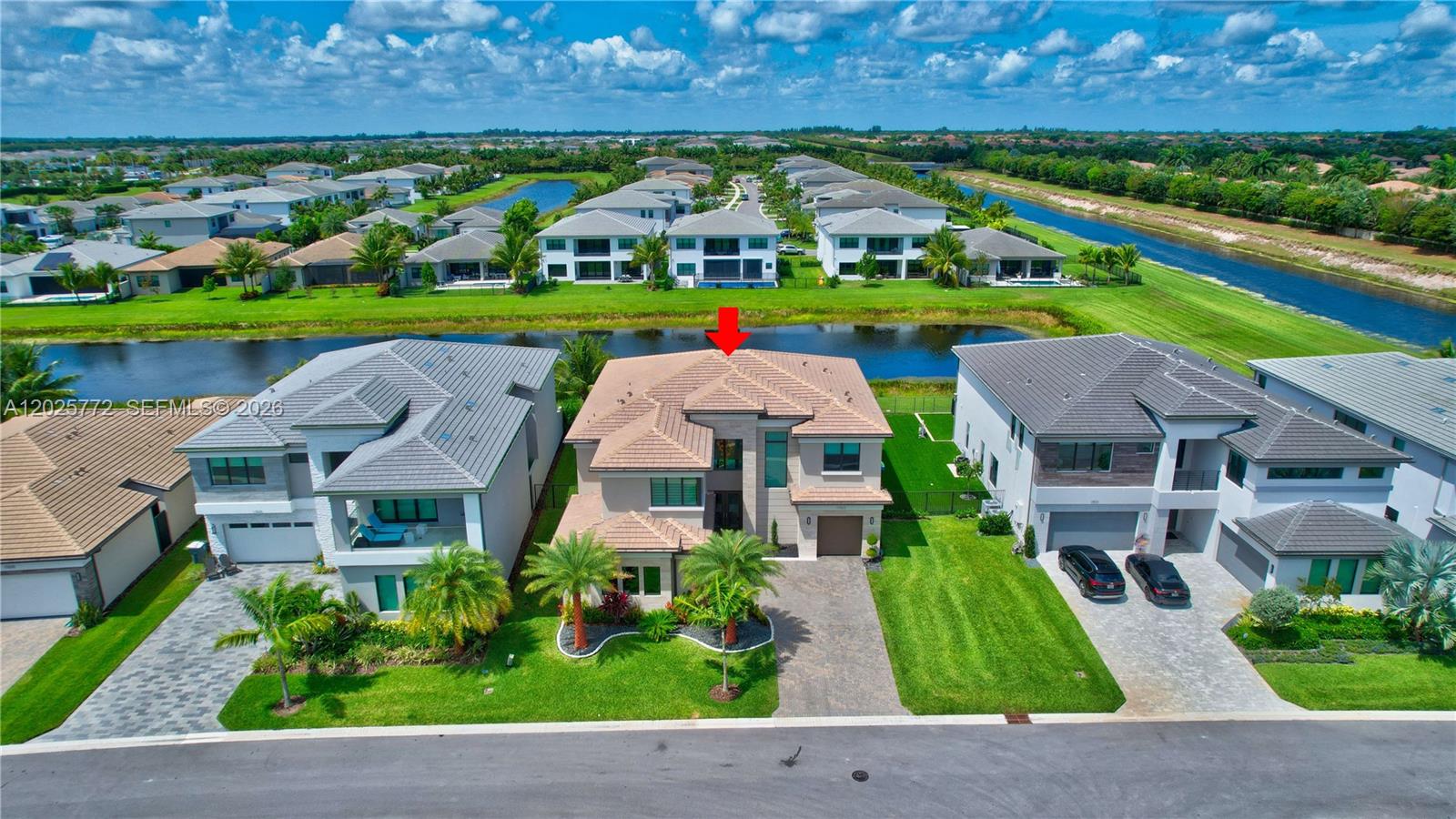 17023 Wandering Wave Avenue Boca Raton, FL 33496 - Photo 2 of 84 an aerial view of multiple houses with a yard