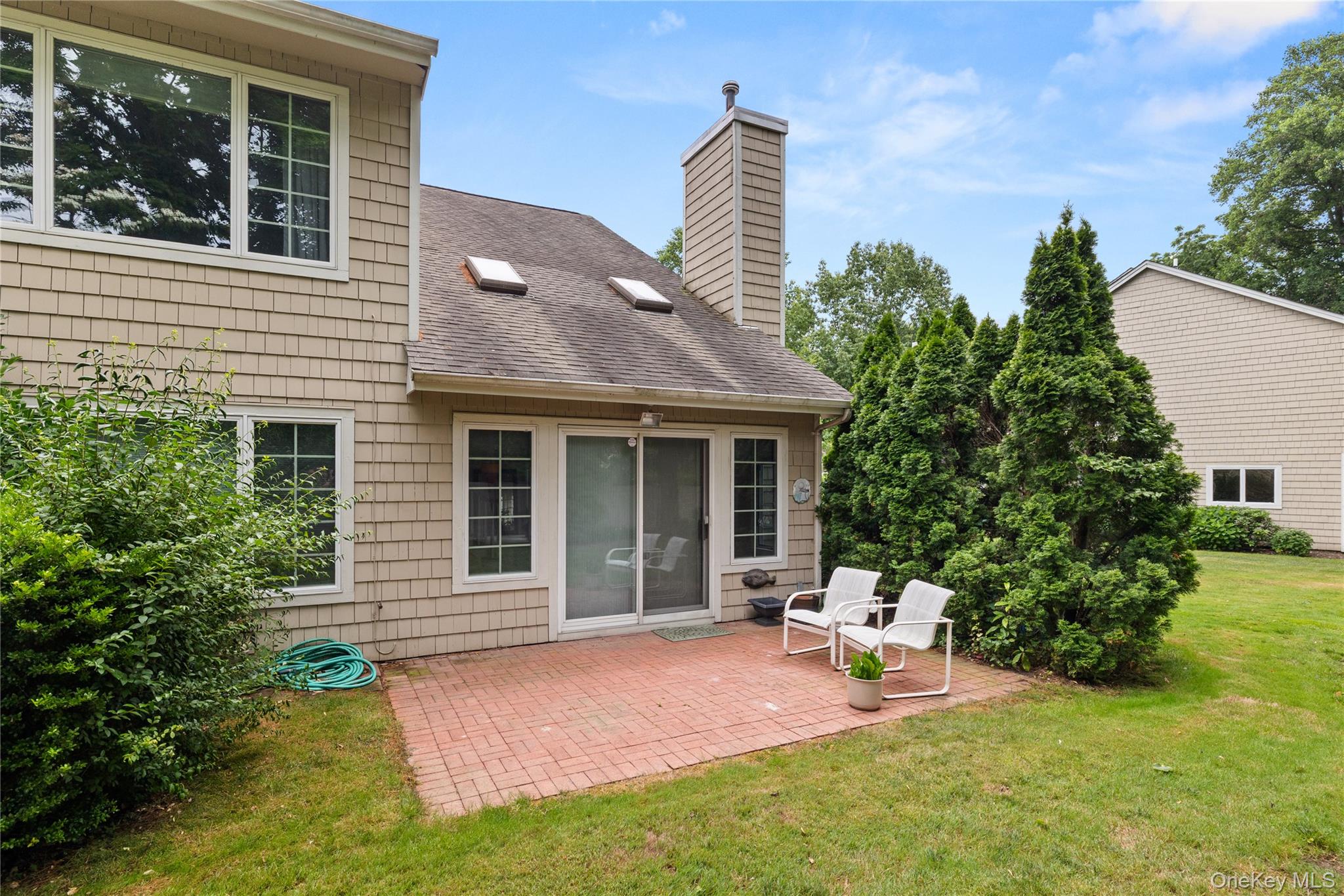 34 Cedar Ridge Lane Bay Shore, NY 11706 - Photo 20 of 27 a view of a house with backyard and sitting area