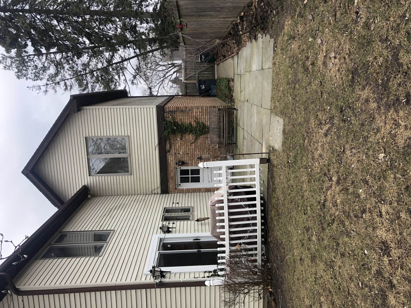 3203 Sprucewood Road Wilmette, IL 60091 - Photo 4 of 8 a view of a patio with a table and chairs and potted plants