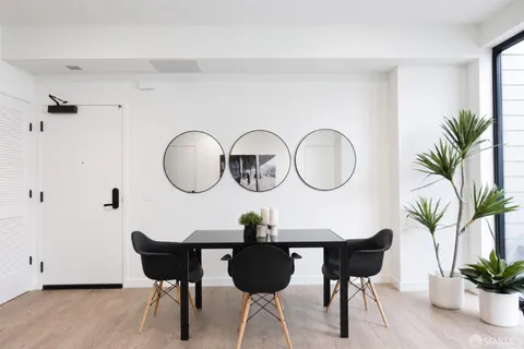 a living room with a potted plant and a table