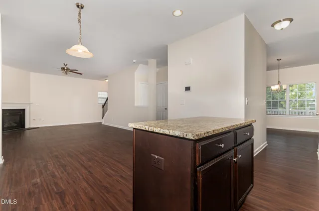 a kitchen with granite countertop stove and wooden floor
