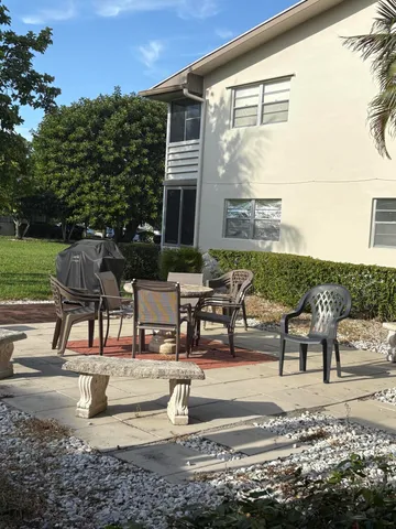 a view of a swimming pool with outdoor seating