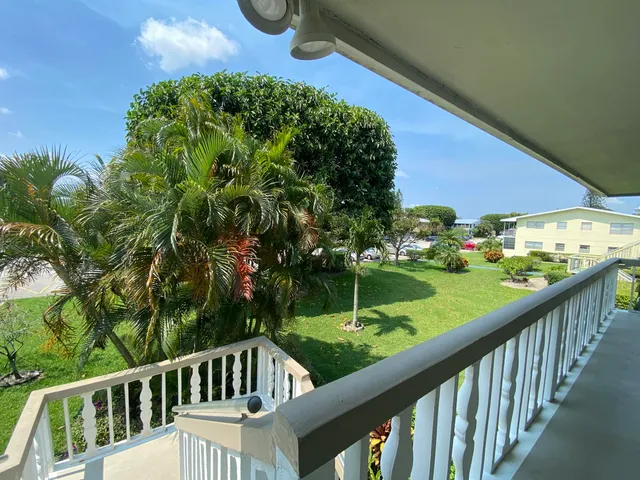 a view of a two chairs in the balcony
