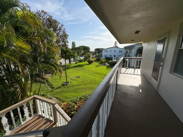 a view of a balcony with two chairs