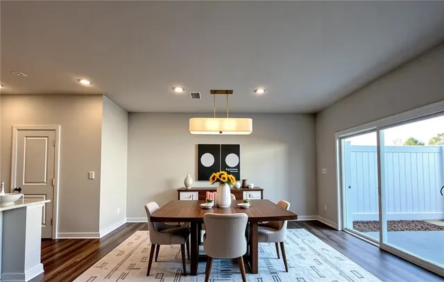 a view of a dining room with a table and chairs