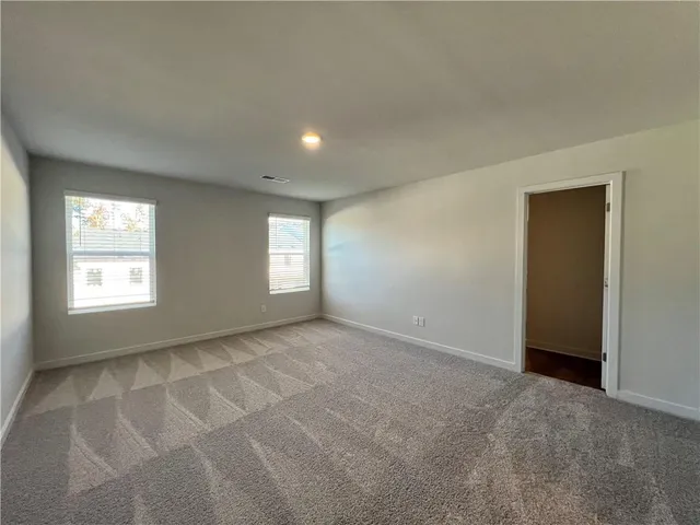 an empty room with a empty space and windows