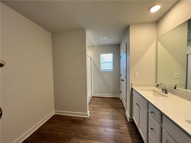 a bathroom with a double vanity sink mirror and shower