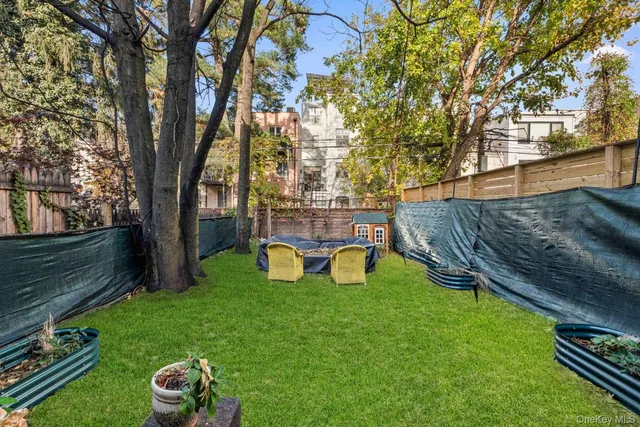 a view of a backyard with wooden fence