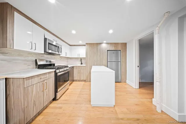 a kitchen with stainless steel appliances granite countertop a refrigerator and a sink