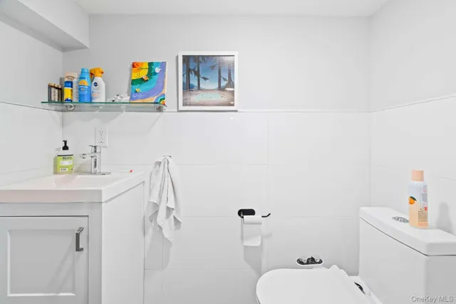 a bathroom with a sink a toilet and a shower curtain