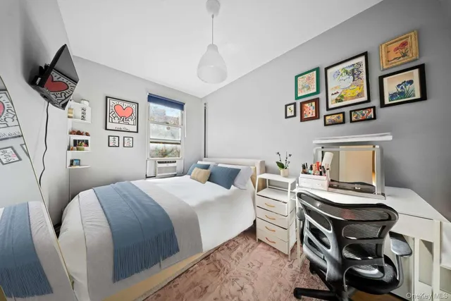 a bedroom with a bed and a desk