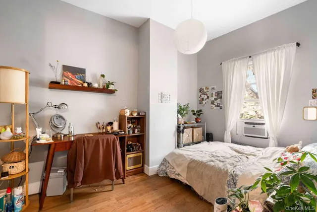 a bedroom with bed and a window