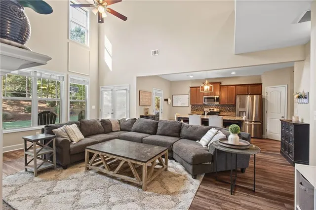 a living room with furniture a table and a large window
