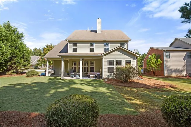 a front view of a house with a garden