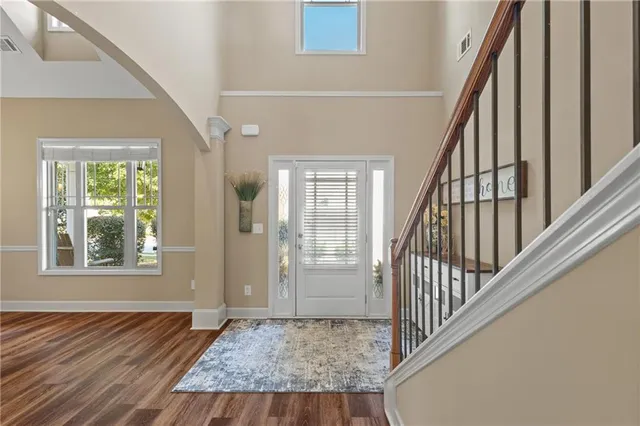 a view of an entryway with wooden floor and door