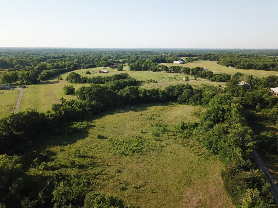 Tbd Ball Road Whitewright, TX 75491 - Photo 3 of 18 Expansive aerial landscape featuring a blend of open fields and densely wooded areas
