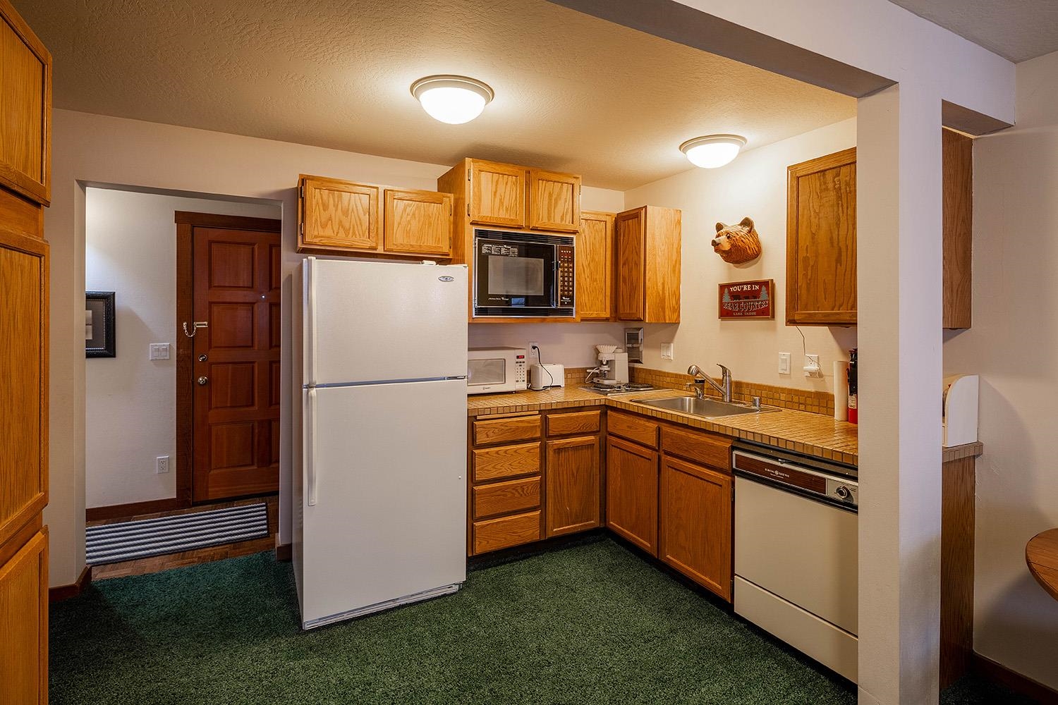 148 Basque Drive Truckee, CA 96161 - Photo 16 of 21 a kitchen with stainless steel appliances granite countertop a refrigerator a stove and a sink with wooden floor