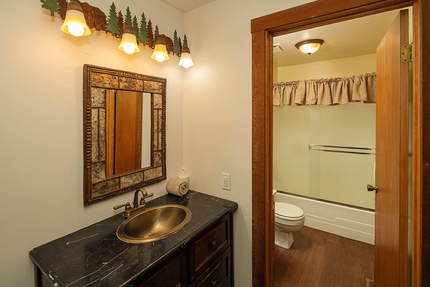 148 Basque Drive Truckee, CA 96161 - Photo 17 of 21 a bathroom with a sink and a mirror