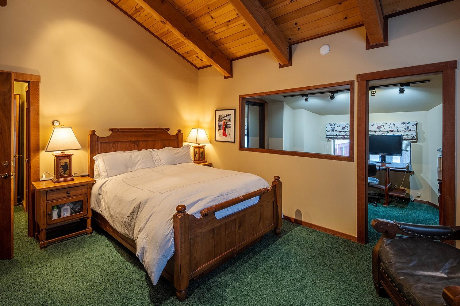 148 Basque Drive Truckee, CA 96161 - Photo 7 of 21 a spacious bedroom with a bed and a lamp on the table