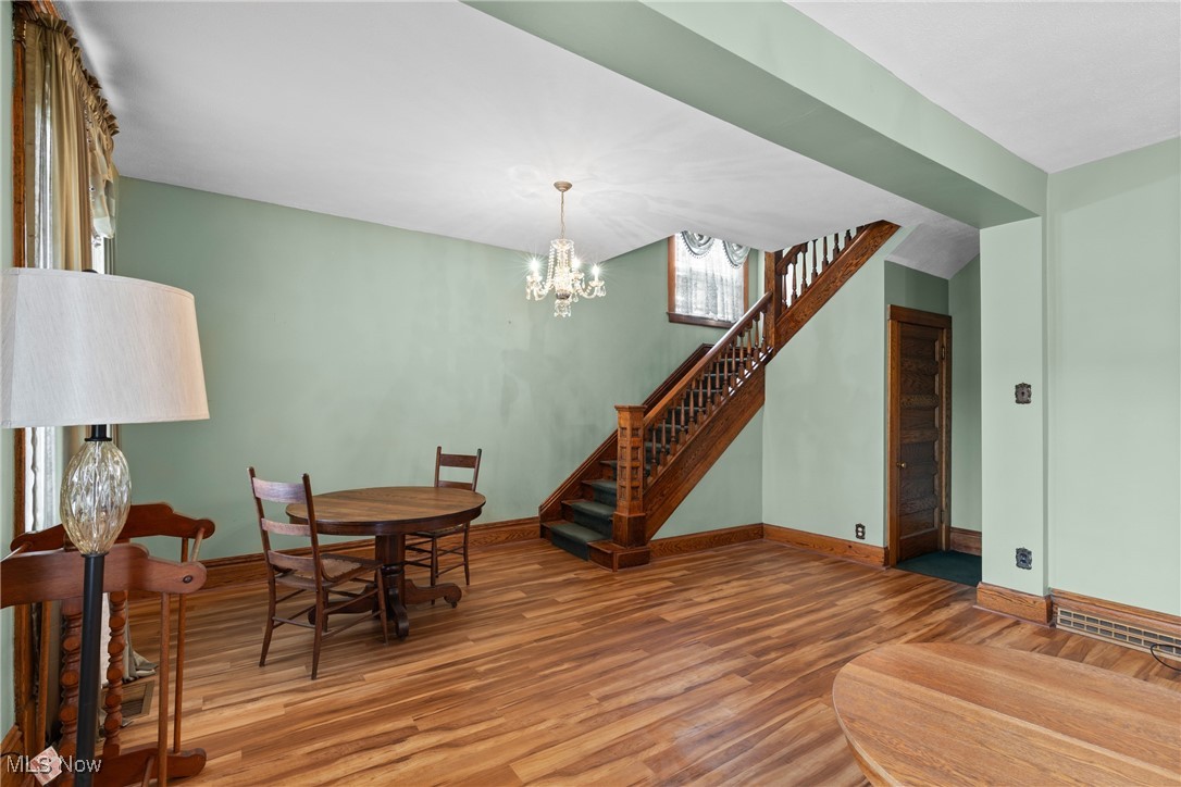 1011 Parriott Avenue Moundsville, WV 26041 - Photo 8 of 44 Dining area featuring stairs, light wood-type flooring, and a chandelier